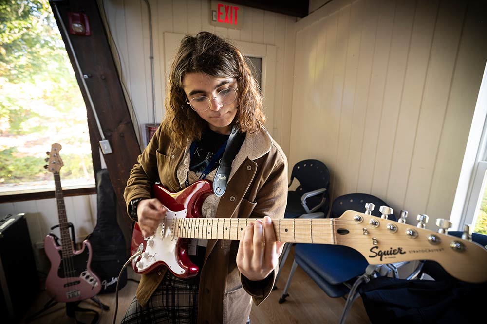 Student playing the guitar